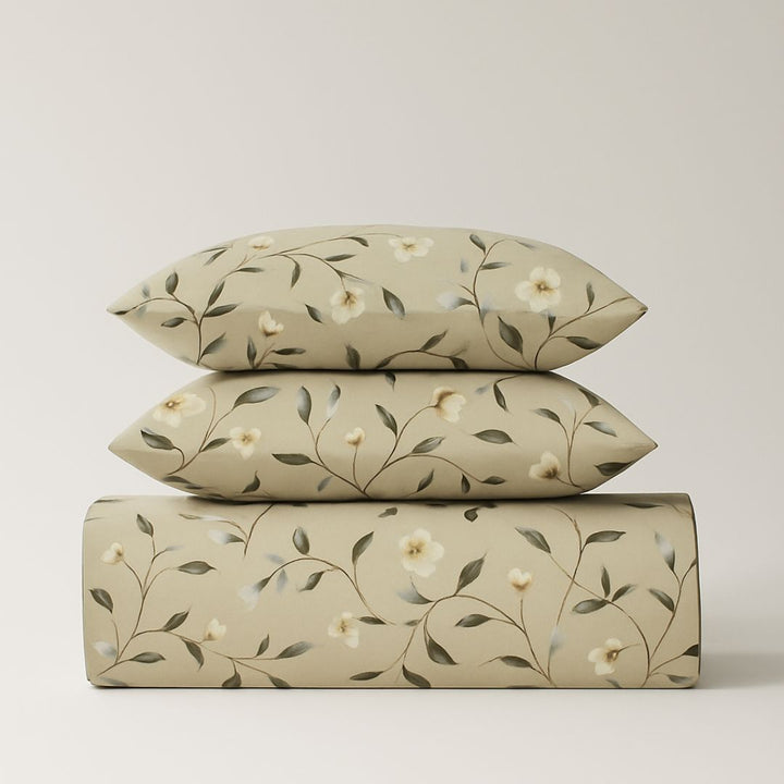Floral patterned bedsheets pakistan with a duvet cover and two pillows on a light background